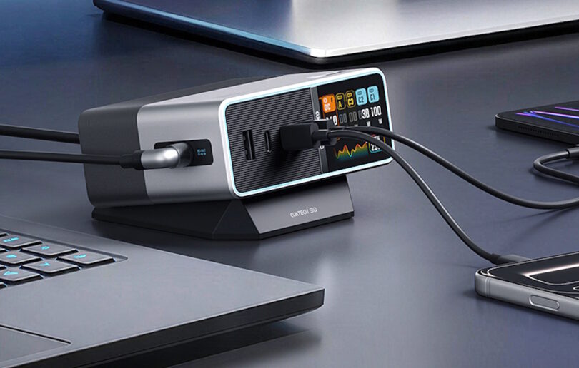 Station de recharge desktop Cuktech 30 Ultra avec écran LED affichant la distribution de puissance en temps réel, connectée à un ordinateur portable et un smartphone.