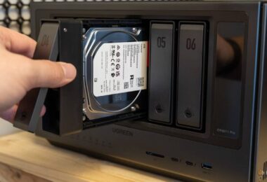 Main d'un utilisateur insérant un tiroir de disque dur Seagate IronWolf 4 To dans la baie d'un NAS multi-baies Ugreen, opération d'extension de stockage NAS en cours.